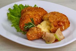 Fried cheese on the plate and wooden background photo