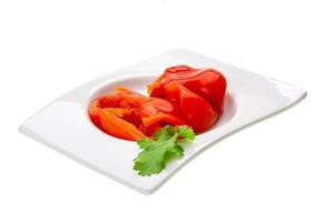 Marinated pepper in a bowl on white background photo