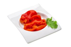 Marinated pepper in a bowl on white background photo