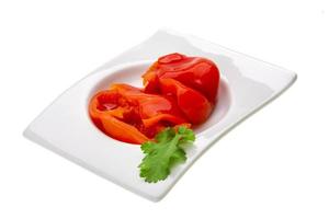 Marinated pepper in a bowl on white background photo