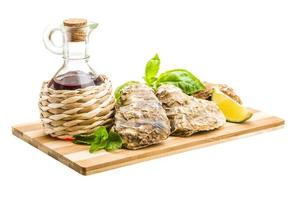 Fresh oyster on wooden board and white background photo