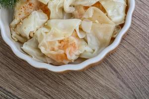 Shrimp wanton in a bowl on wooden background photo