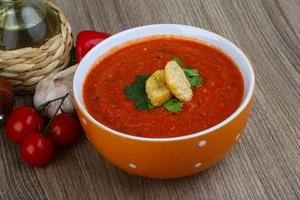 Gazpacho in a bowl on wooden background photo