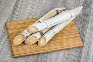 Sugar sticks on wooden board and wooden background photo