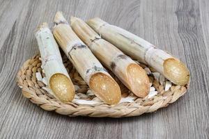 Sugar sticks on wooden board and wooden background photo