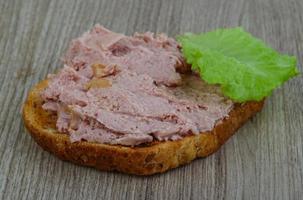 Pate sandwich on wooden background photo