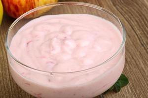 Srawberry yoghurt in a bowl on wooden background photo