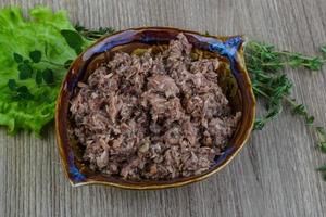 Canned tuna in a bowl on wooden background photo