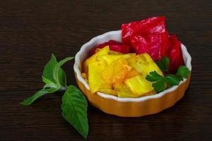 Pickled cabbage in a bowl on wooden background photo