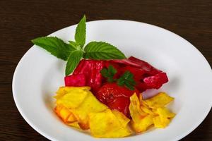 Pickled cabbage on the plate and wooden background photo