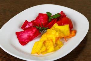 Pickled cabbage on the plate and wooden background photo