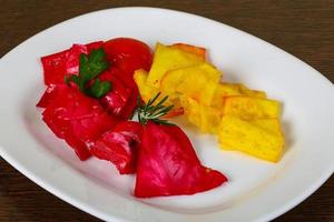 Pickled cabbage on the plate and wooden background photo