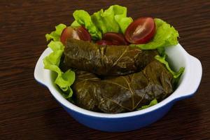 Dolma in a bowl on wooden background photo