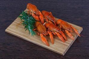 Crayfish on wooden board and wooden background photo