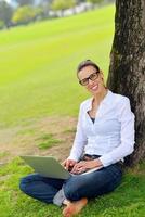 woman with laptop in park photo