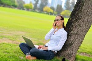 woman with laptop in park photo