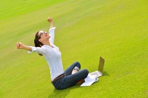 woman with laptop in park photo