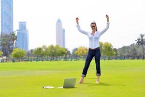 woman with laptop in park photo