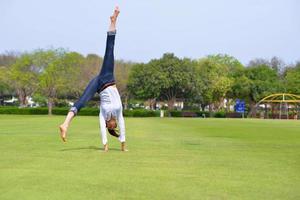 young woman jumping in park photo