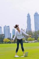 woman with laptop in park photo