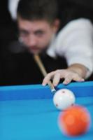 young man play pro billiard game photo