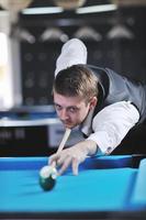 young man play pro billiard game photo