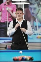 young man play pro billiard game photo