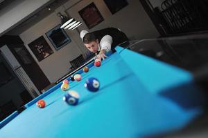 young man play pro billiard game photo