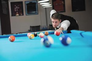 young man play pro billiard game photo