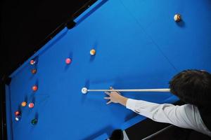 young man play pro billiard game photo