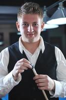 young man play pro billiard game photo