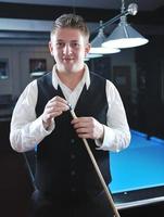 young man play pro billiard game photo