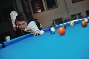 young man play pro billiard game photo