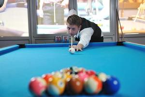 young man play pro billiard game photo