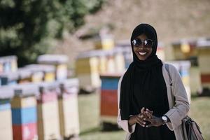 african  muslim businesswoman portrait  on small local  honey production farm photo