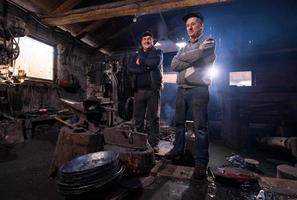 portrait of two generations confident blacksmith photo