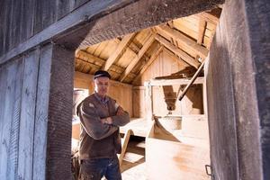 portrait of a miller in retro wooden watermill photo