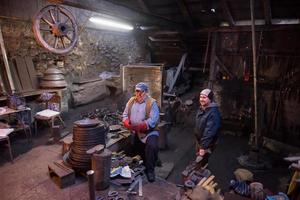 portrait of two generations traditional blacksmith photo