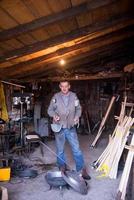 A blacksmith worker showing handmade products ready for sale photo