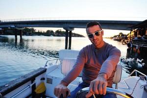 portrait of happy young man on boat photo