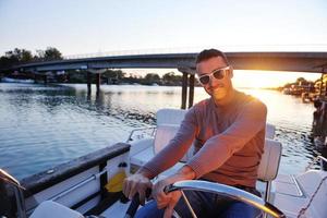 portrait of happy young man on boat photo