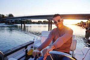 portrait of happy young man on boat photo