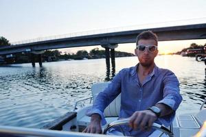 portrait of happy young man on boat photo