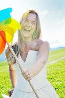 beautiful bride outdoor with colorful windmill toy photo