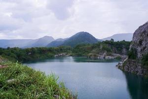 The limestone mountains after the concession explosion during the rainy season form a large and beautiful pond. photo