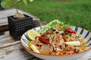 Spicy minced pork salad served with fresh vegetables Minced pork salad is a popular traditional Thai food of Thailand. Spicy Minced Pork Salad is also called Larb Moo. photo