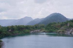 The limestone mountains after the concession explosion during the rainy season form a large and beautiful pond. photo