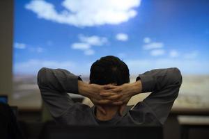 young man dreaming clouds on presentation photo