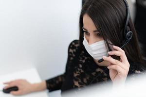 call center operator in medical mask photo