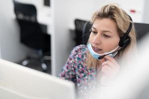 call center operator in medical mask photo